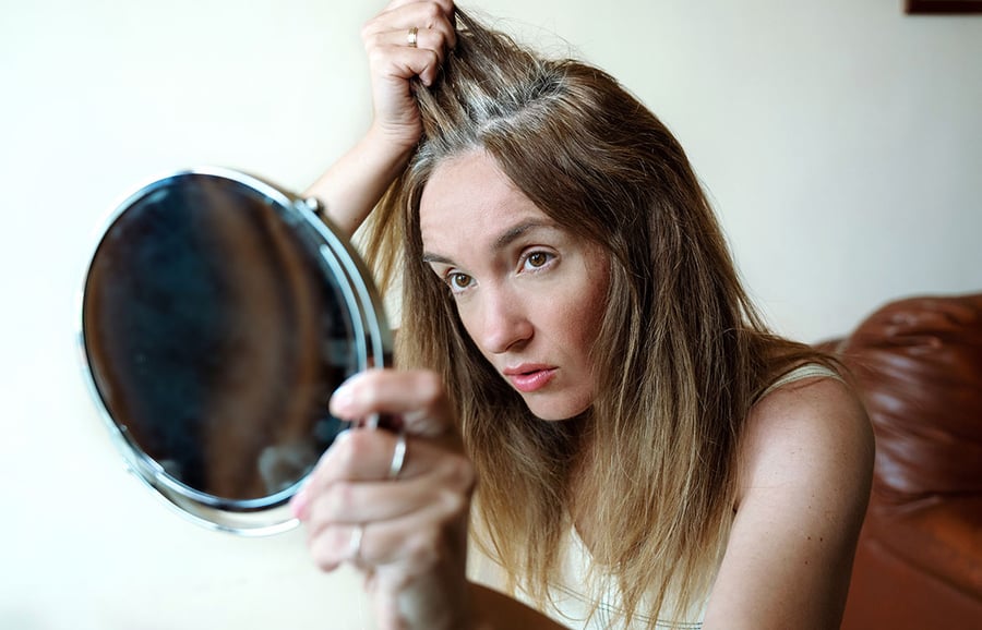 Gray-hair-woman-looking-in-mirror